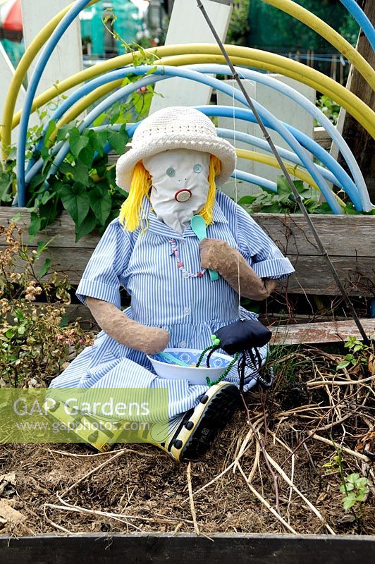 Little Miss Muffet girl scarecrow sitting in compost, Paddock Allotments 