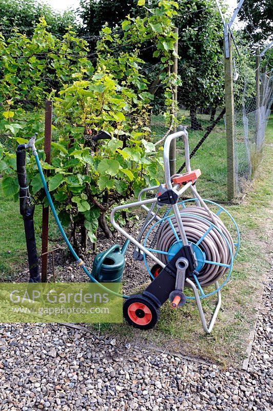 Portable hose. Hosepipe on reel with wheels and connected to tap, Bayford, Hertfordshire