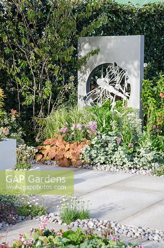 Art panels designed by Susan Bradley, granite paving and plants including Heucherella 'Sweet Tea', Aquilegia and Lamium manucatum  - 'Solar Chic' Show Garden, Silver Award, RHS Malvern Spring Show 2013