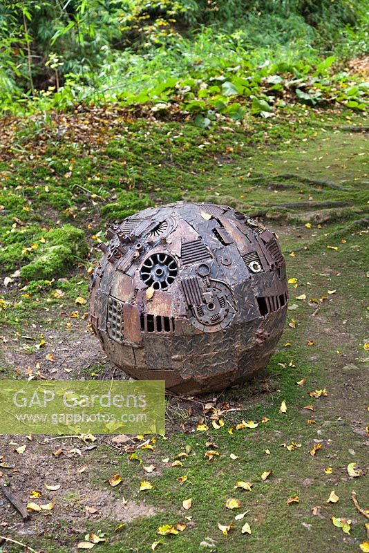 Sphere by Mike Coleman made from steel and aluminium. The Hannah Peschar Sculpture Garden designed by Anthony Paul, landscape designer