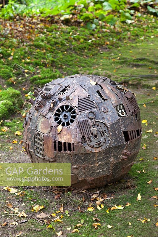 Sphere by Mike Coleman made from steel and aluminium. The Hannah Peschar Sculpture Garden designed by Anthony Paul, landscape designer