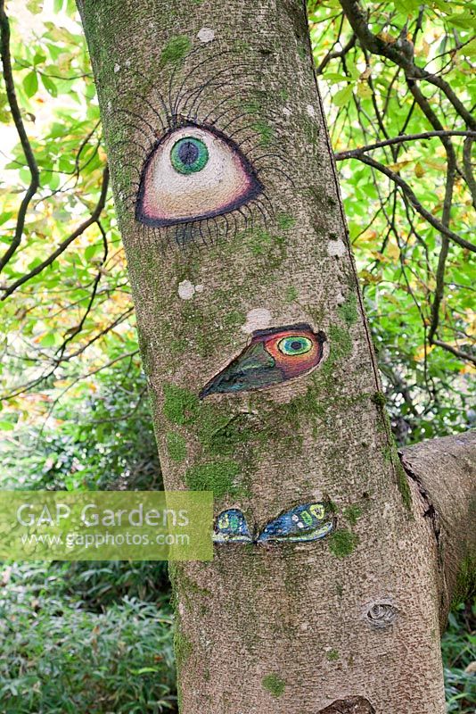 Someone's Watching Me by Peter Bye acrylic on tree. The Hannah Peschar Sculpture Garden designed by Anthony Paul, Landscape Designer
