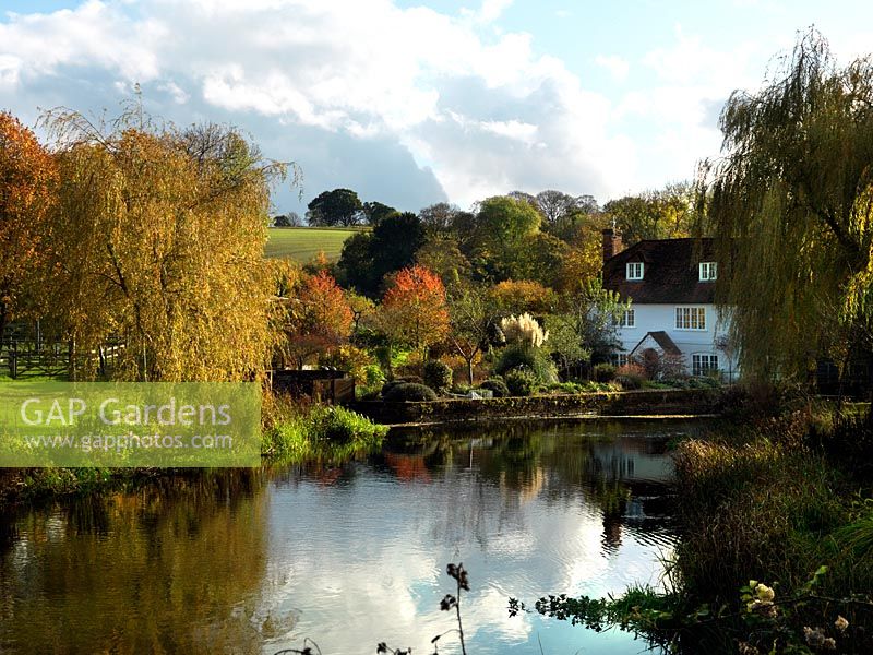 A mill house and garden beside the river Test.