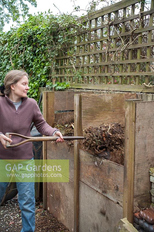 Turning garden compost from one heap to another