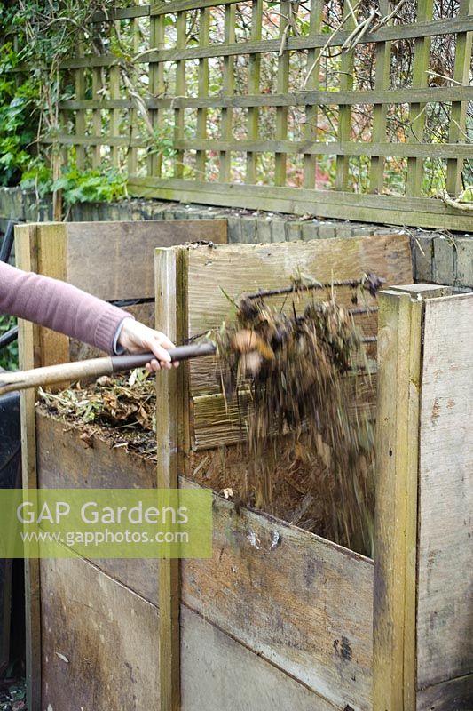 Turning garden compost from one heap to another