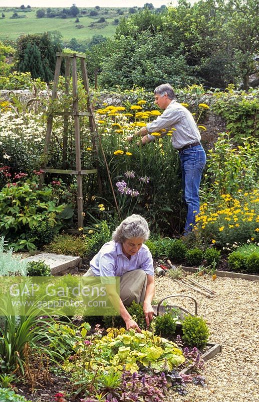 Man and woman tending their garden.