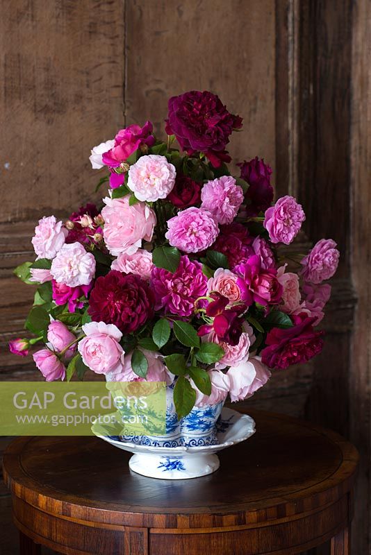 Red and pink roses in a cut flower arrangement on a side table