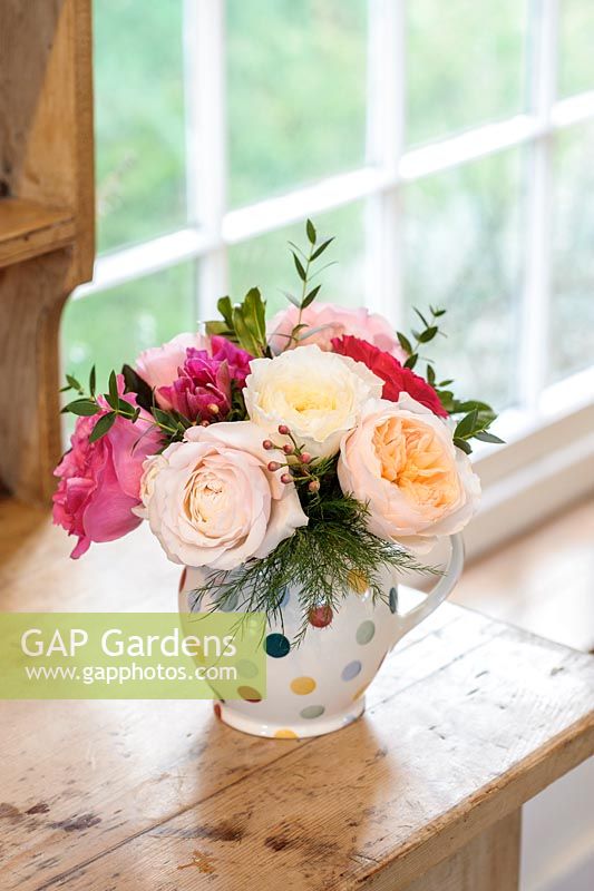Pink, cream and peach roses in an  arrangement. Cut flower roses bred by David Austin Roses