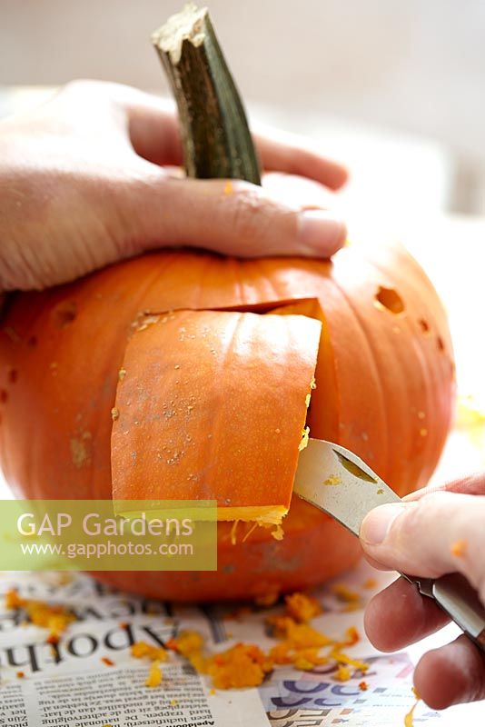 Carving Halloween pumpkin - cutting square hole with knife 