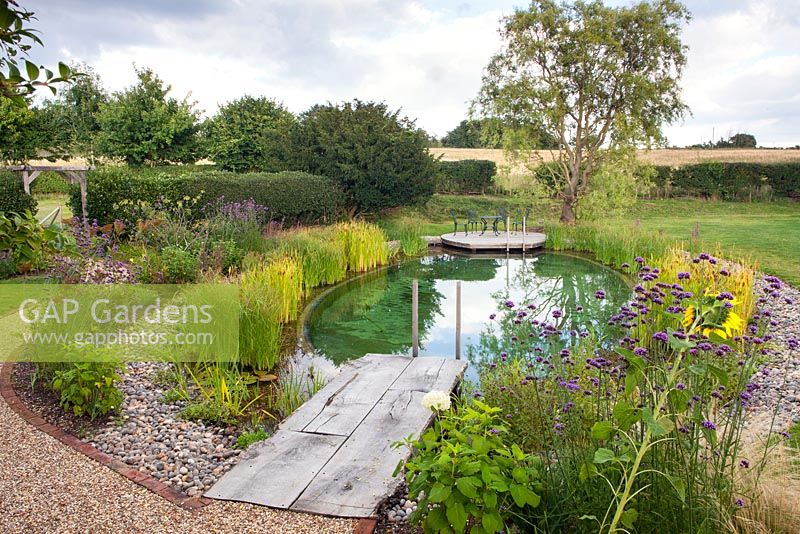 View of wooden decking leading to Swimming Pond. 