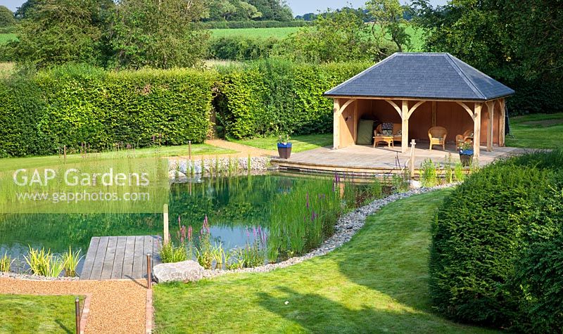 View of covered seating area next to the swimming pond.