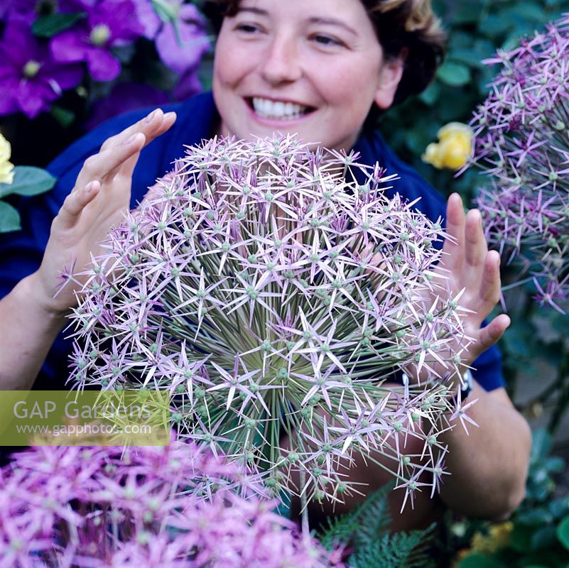 Katie Moray pictured behind a huge Allium cristophii.