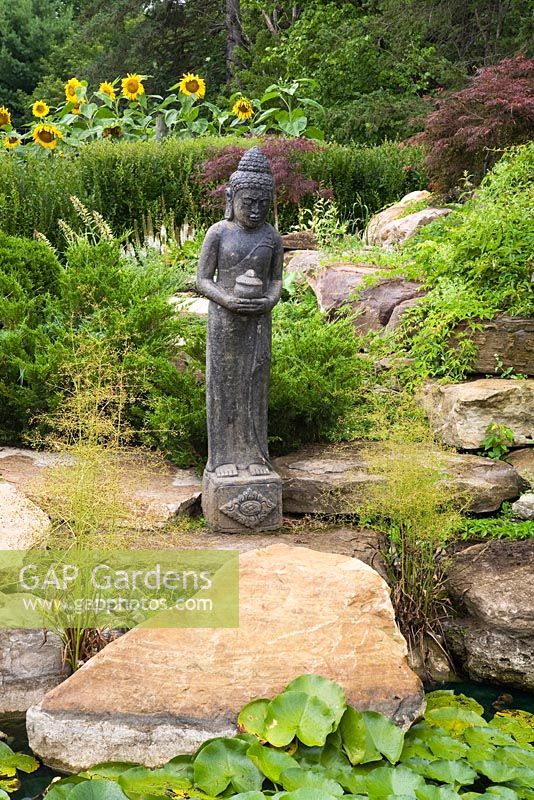 Indonesian goddess statue in the Zen garden at the Route des Gerbes d'Angelica garden, Mirabel, Quebec, Laurentians, Canada