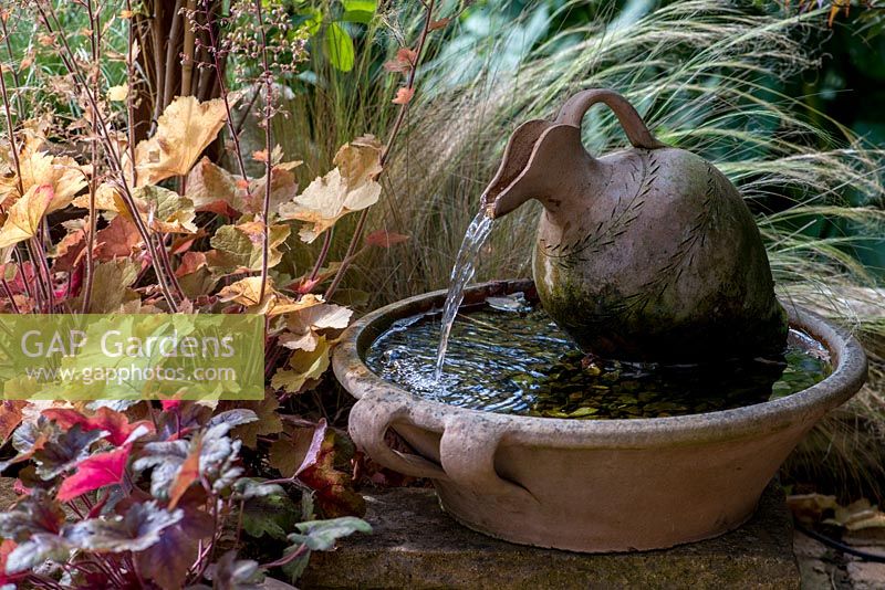 A small water feature made from terracotta.