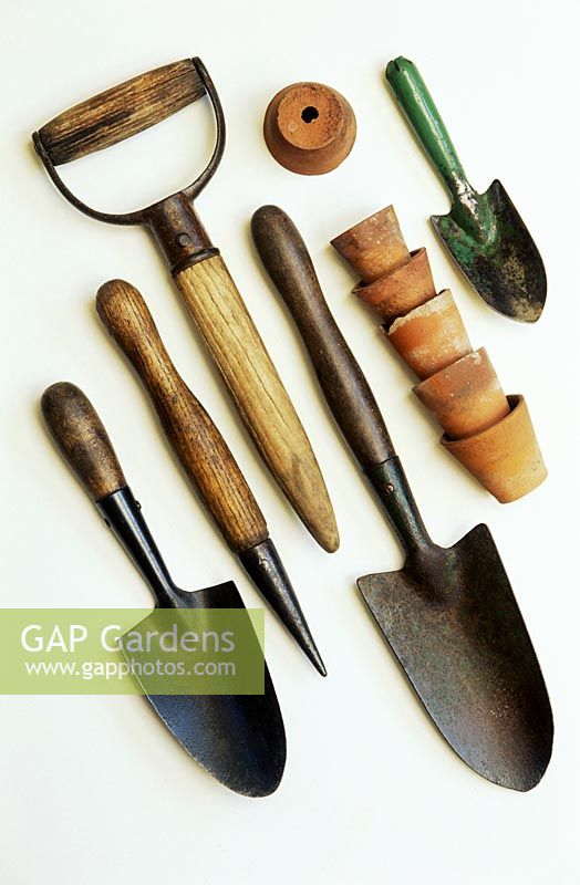 Hand trowels, dibbers, childs hand trowel and old flower pots 