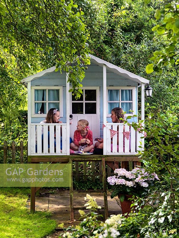 Scarlet 12,  Olivia 7 and Maja 13 playing in the raised children's summerhouse.