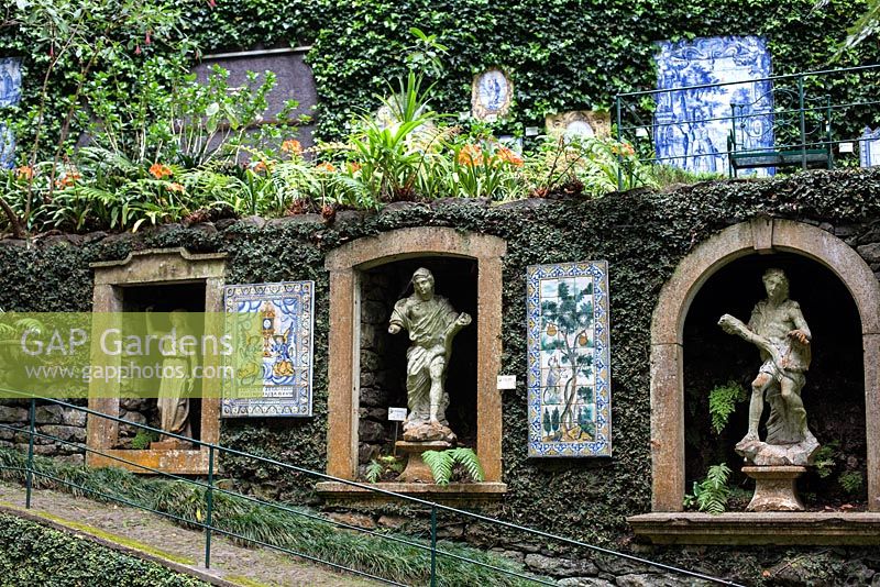 Tiled panels, niches filled with classical statuary, carved into the walls at Monte Palace Tropical Garden, Madeira