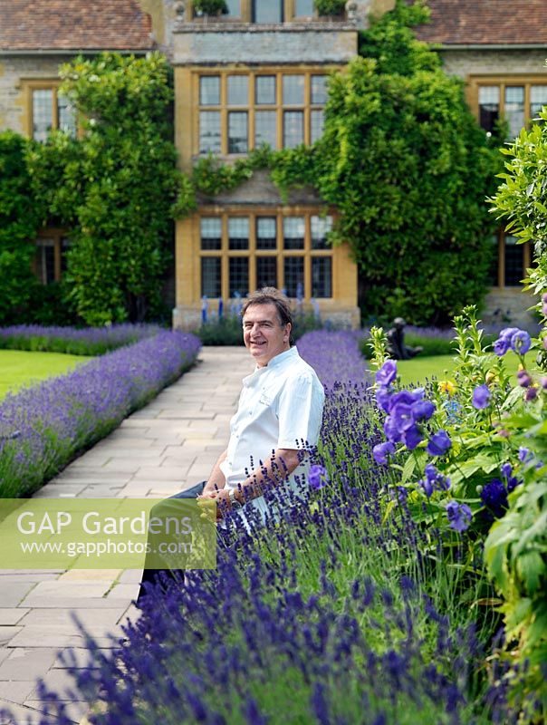 Raymond Blanc, celebrity chef, pictured by the lavender walk leading to his hotel and restaurant, Le Manoir aux Quat'Saisons.