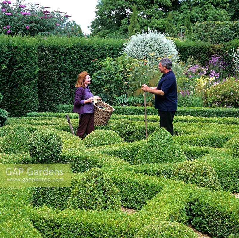 Chris and Sheila Bissell clear up box clippings from the gravel in their knot garden.