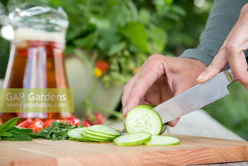 Slicing and dicing Cucumber, Strawberry and Mint to add to the jug of Pimm's