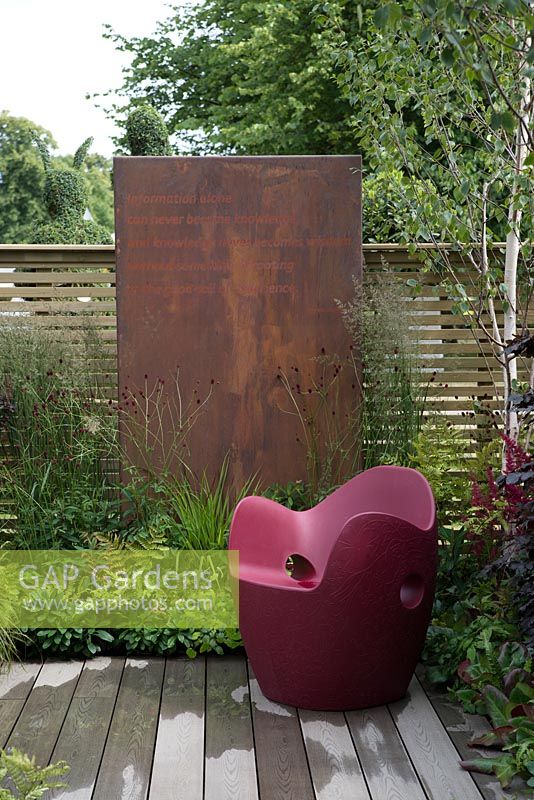 Slatted fencing with panel feature and O-nest Chair by Tord Boontje - Foundation for Growth Garden, RHS Hampton Court Palace Flower Show 2015