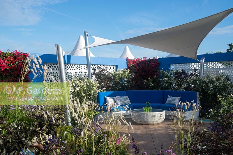Blue curved bench seating with white canvas sail - Noble Caledonia garden, Spirit of the Aegean, RHS Hampton Court Palace Flower Show 2015