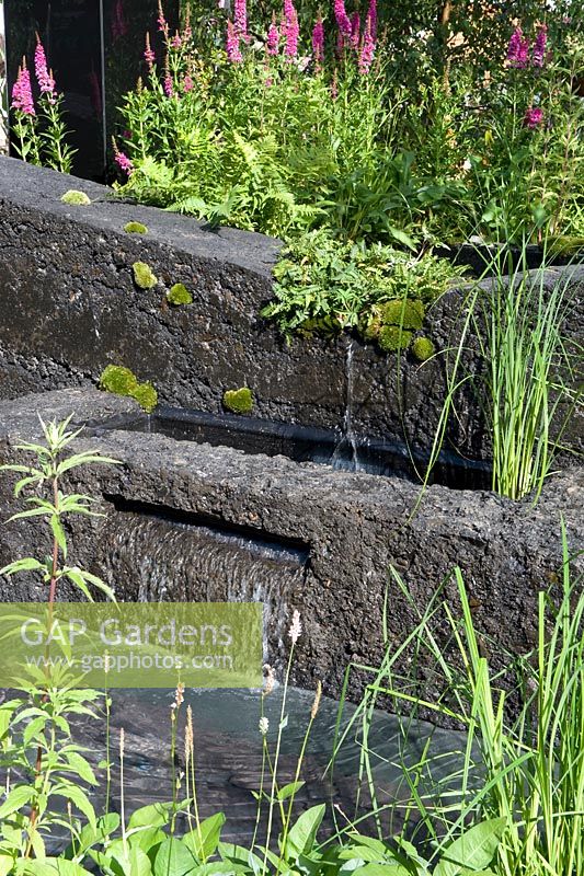 Water feature constructed from spoil from coal mining. Hadlow College Green Seam garden. RHS Hampton Court Flower Show, 2015