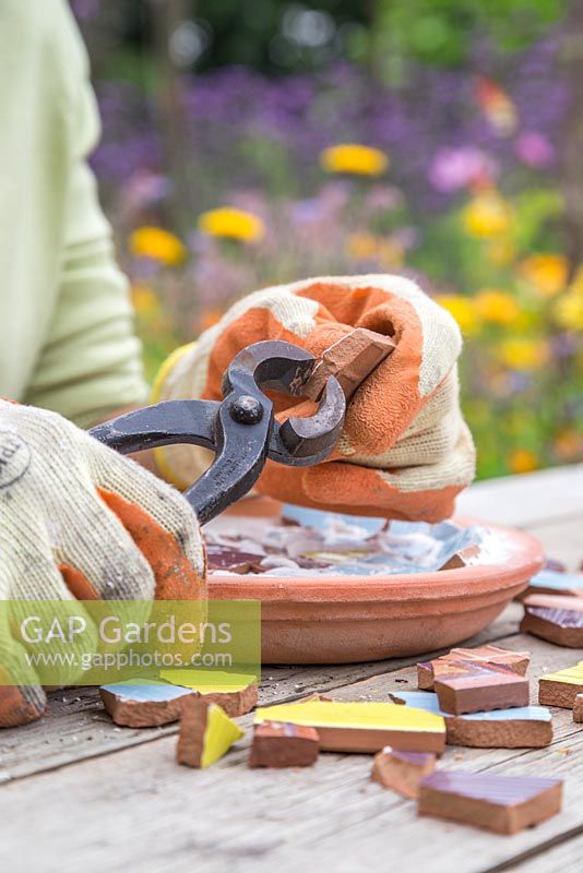 Using tile nippers to cut mosaic pieces into required shape