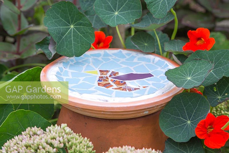 Mosaic bird bath made from broken tiles