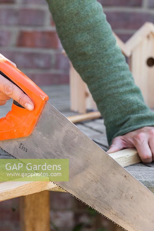 Use a ruler and measure the roof of the bird house, sawing off wooden batons to match the required lengths