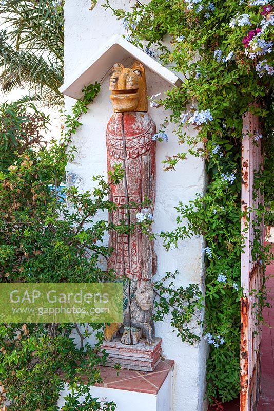 Gate post with wooden sculpture - Entrance to patio area. 
