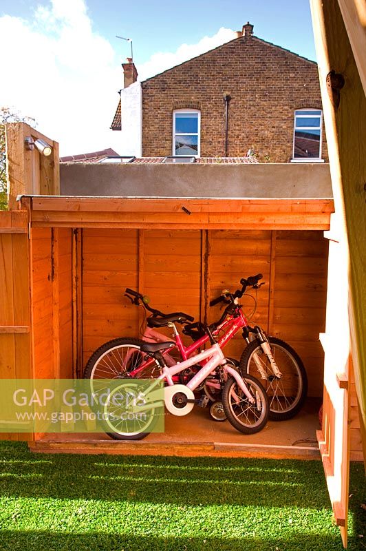 Shed to store family bikes. Small urban contemporary town garden. Ansari garden, Harrow