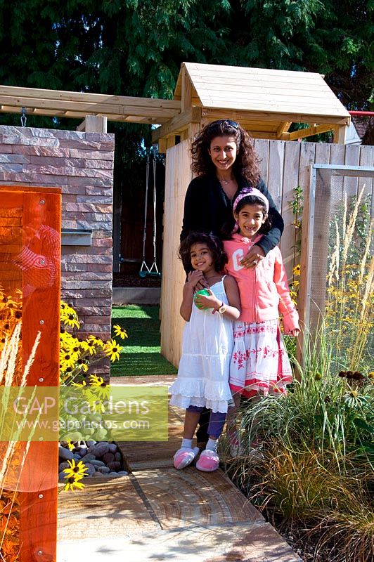 Small urban contemporary town garden owner and her daughters children young children portrait - Ansari garden, Harrow