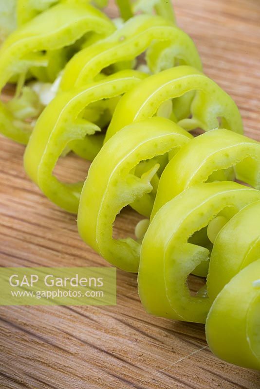 Pepper 'Hungarian Hot Wax' - Capsicum annuum fruit finely sliced on chopping board