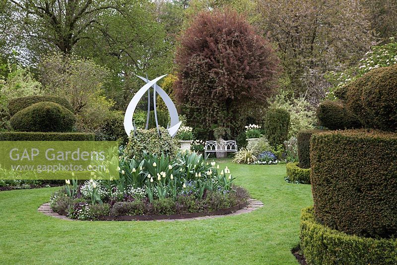 White Garden with Tulipa 'Francoise', sculpture by Pete Moorhouse, Yew topiary,  Chenies Manor Gardens, Buckinghamshire 