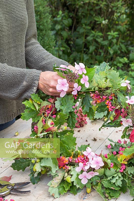 Evenly distribute the hydrangea flowers as you add them to the wreath