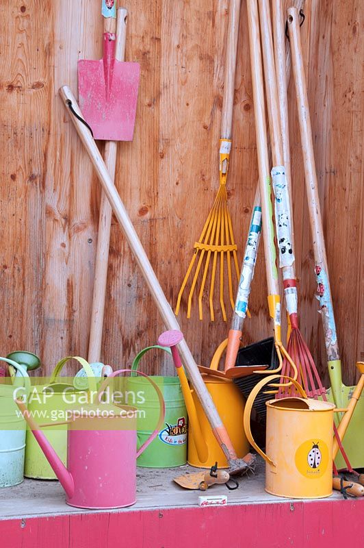 Store for childrens' gardening equipment, including trowels, rakes, spades and watering cans