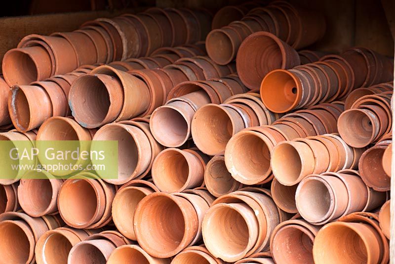 Piles of terracotta pots stored in a shed at West Dean Kitchen Gardens, West Sussex
