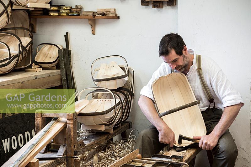 Charlie Groves making a traditional Sussex trug. Pinning each willow board in place with cut copper tacks.