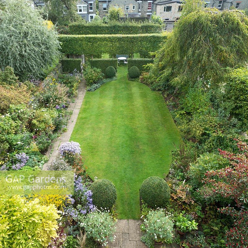 Aerial view of formal town garden in summer with box topiary, pleached field maples. September