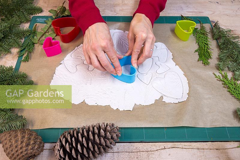 Use the heart shaped cutters to cut out clay hearts which feature the foliage imprints