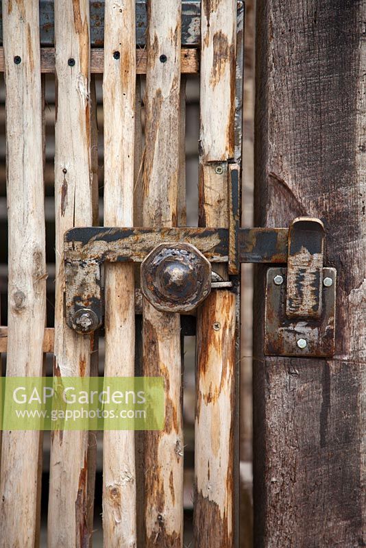 Close-up on hinge made by local blacksmith with recycled metal at le Prieuré Notre-Dame d'Orsan