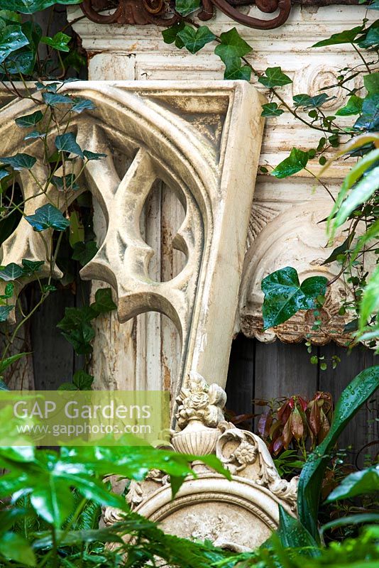 Fire place with Hedera helix, Fatsia japonica and Asplenium scolopendrium, Lucille Lewins, small office court yard garden in Chiltern street studios, London. Designed by Adam Woolcott and Jonathan Smith