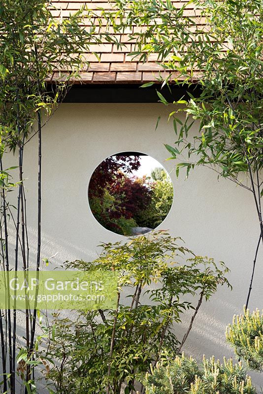 Circular view through garden building, with Phyllostachys nigra and Nandina domestica - A Japanese Reflection, RHS Malvern Spring Festival 2016