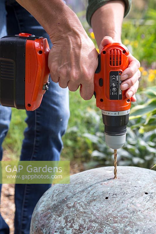 Place the vintage copper planters upside down and use a drill to create drainage holes