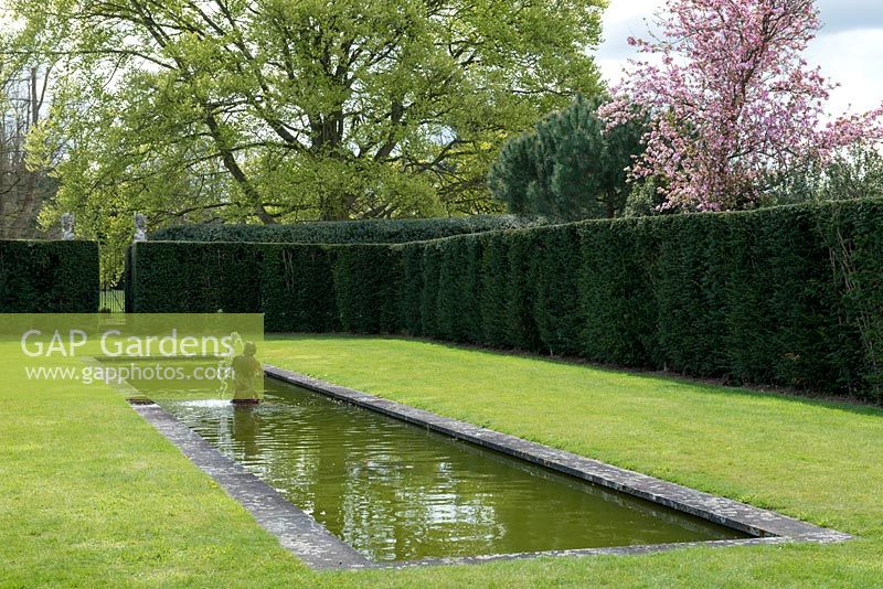 The Italian Garden, designed by Rupert Golby. A formal garden room with long reflecting pool and fountain, enclosed by a yew hedge.