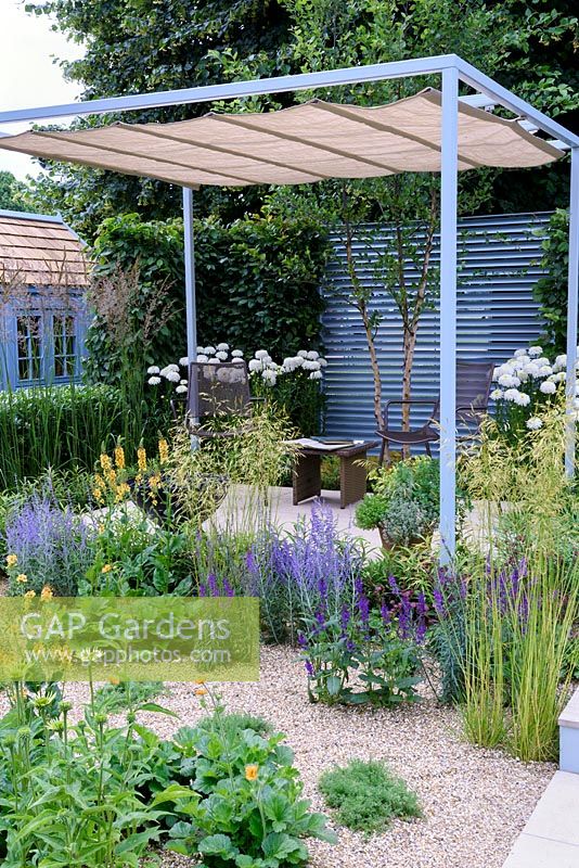 Retreat Garden. Urban Garden, steel pergola with retractable shade and louvered steel backdrop. Designer: Martin Royer, Sponsors: Final5. RHS Hampton Court Palace Flower Show 2016