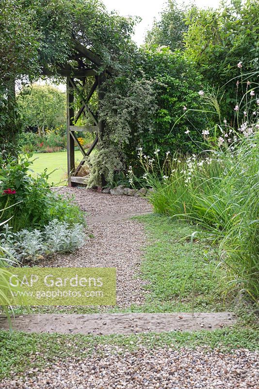 Gravel path leading through the White Garden. A Pergola links to the next garden