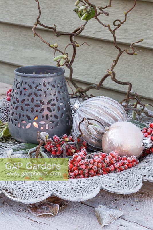 Silver platter containing frosted baubles, Cotoneaster berries and Corylus avellana branch