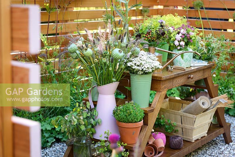 Cut flowers in vases with Alchemilla mollis, Rosa 'Blush Noisette', eryngiums, euphorbias, astrantias, sweet williams, grasses and seedheads in Katie's Lymphoedema Fund: Katie's Garden, RHS Hampton Court Palace Flower Show 2016. Design: Noemi Mercurelli and Carolyn Dunster